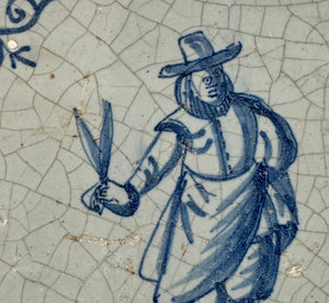 T57)17th century delft tile with man with succors