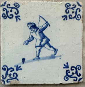 T62 delft tile with child playing with a top