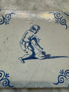 T52) 17 th century delft tile with child playing