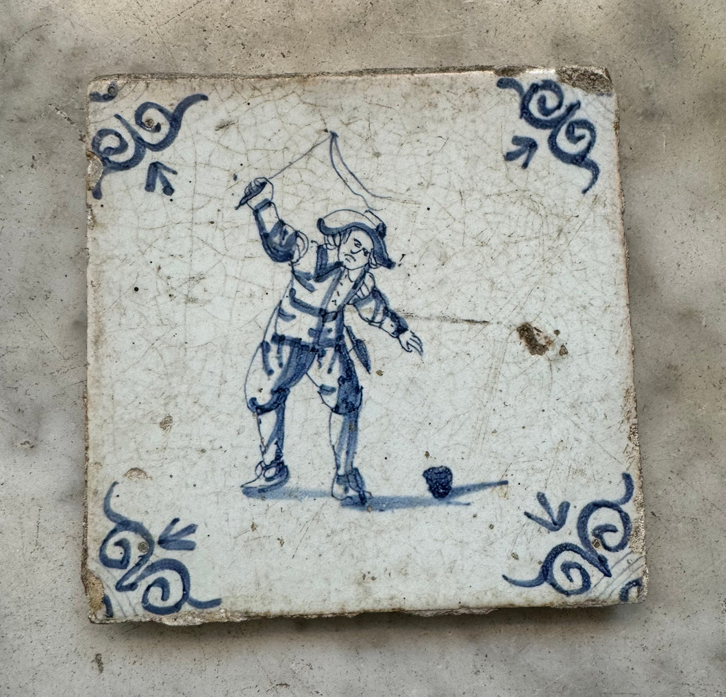 T11) 17th century delft tile , child playing with a top