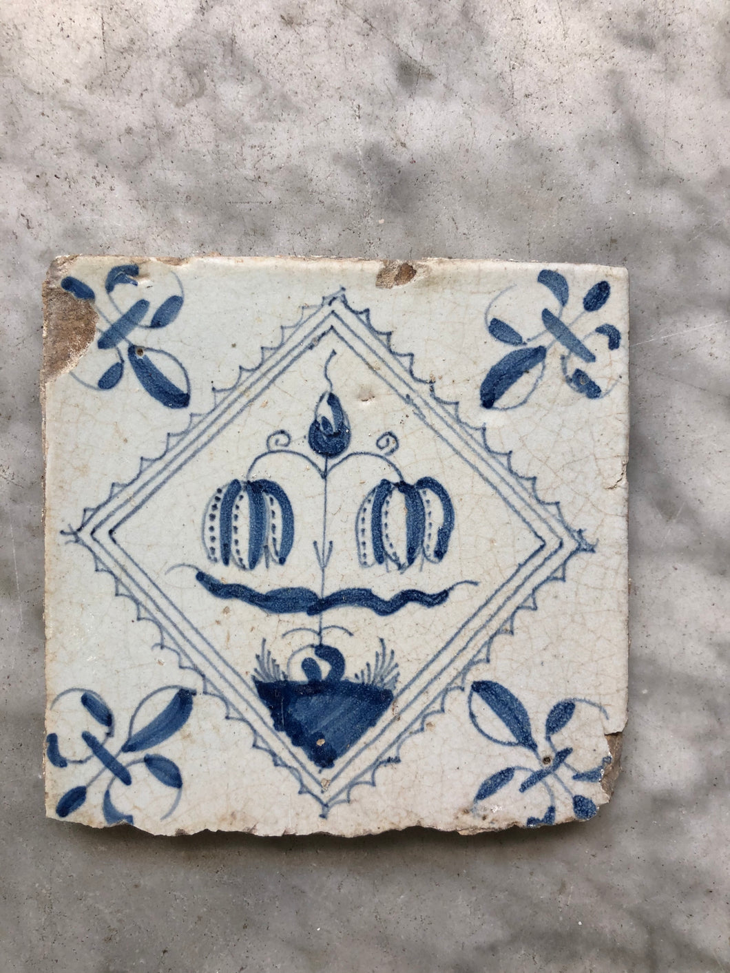 17 th century delft tile with hanging tulips