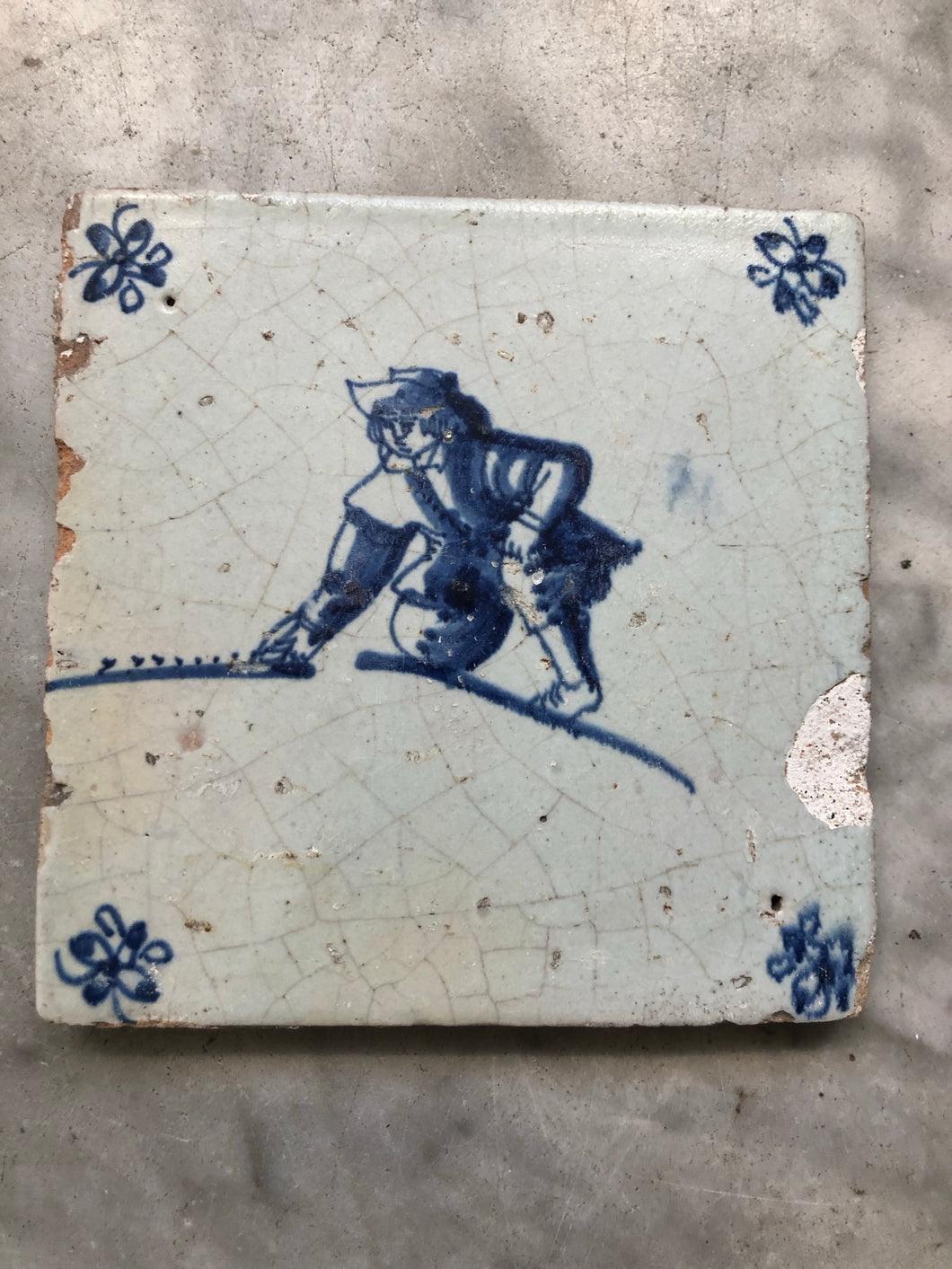 Delft handpainted dutch tile with boy playing with a marble