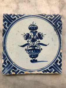 17 th century delft tile with flowervase