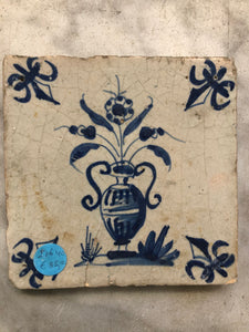 17 th century delft tile with flowervase